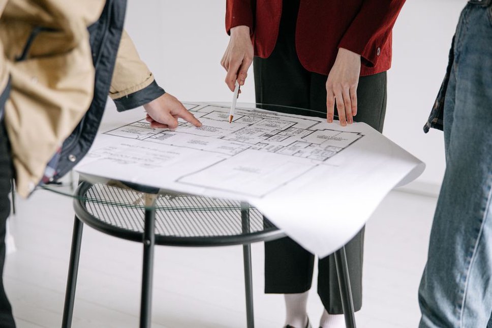 Architect and clients reviewing building plans