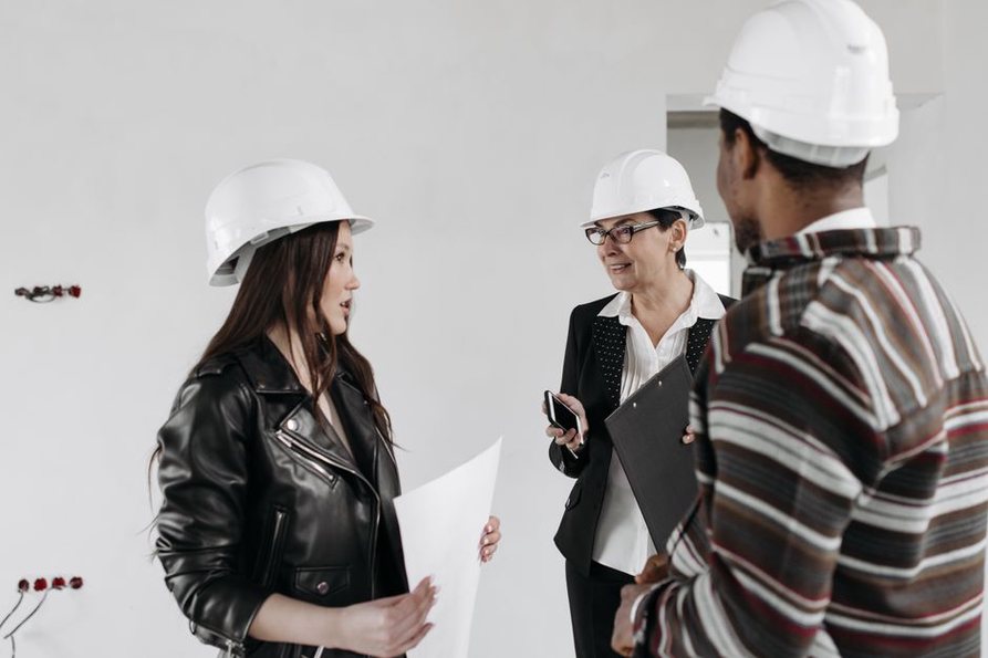 Architects and engineers discussing a project blueprint in an office setting