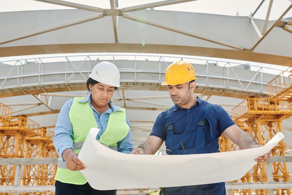 Architects and engineers reviewing project plans in a meeting