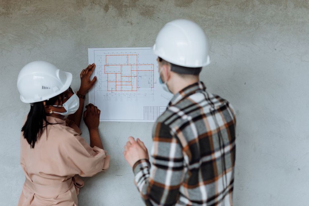 Architects reviewing site plans on a construction site