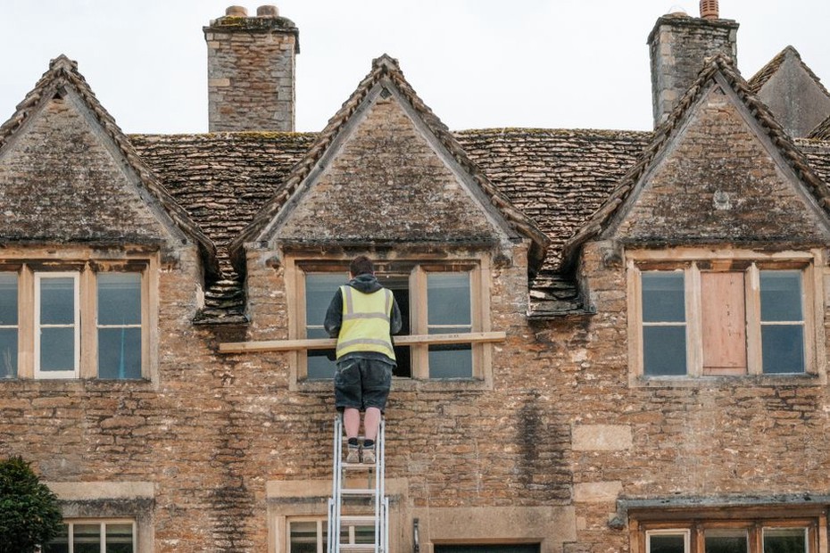 Craftsman meticulously restoring architectural details