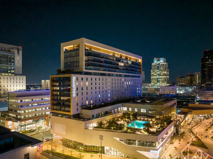 Modern mixed-use building with illuminated windows
