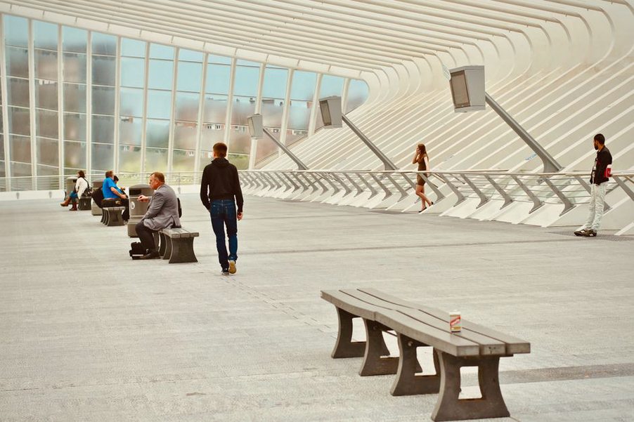 People interacting in a bright, naturally lit public area