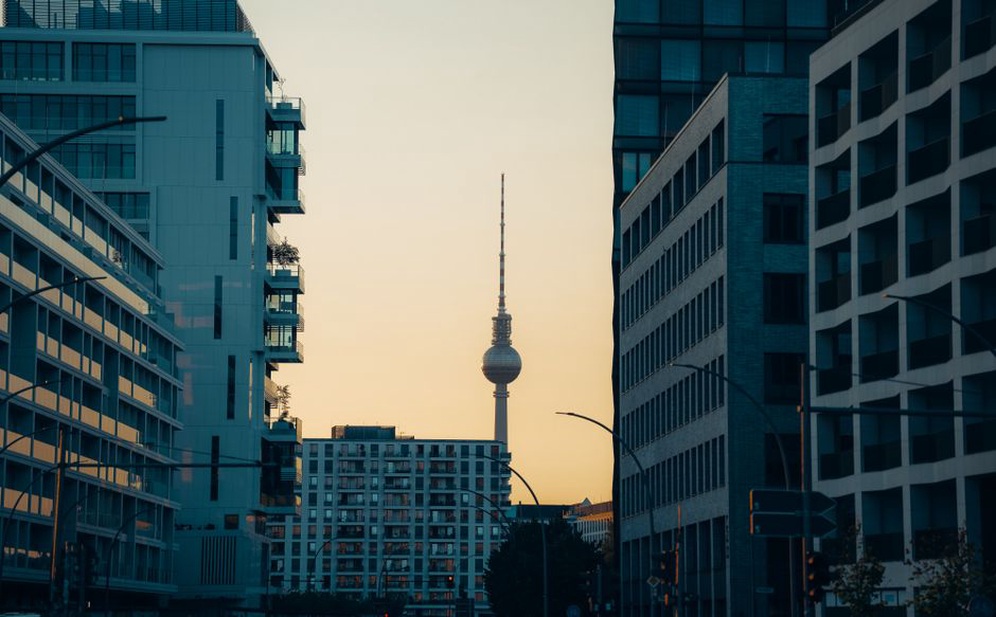 A city skyline featuring an iconic landmark at sunset