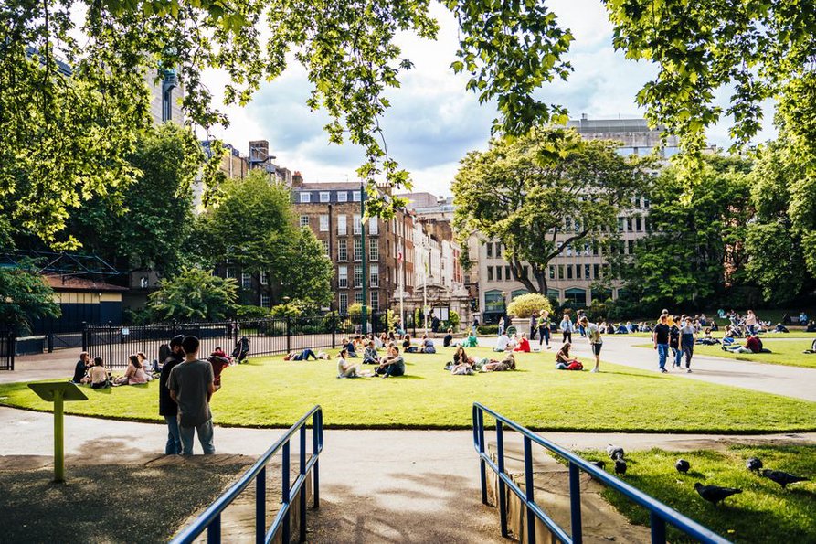 People enjoying a sunny day in a city park