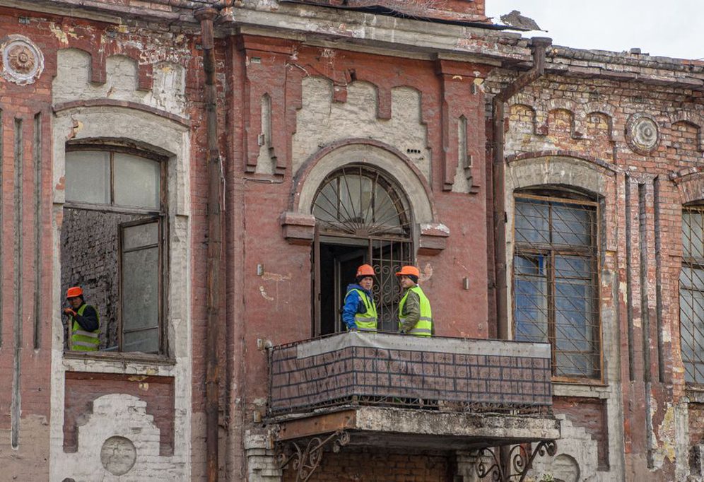Architect documenting brickwork and original window details