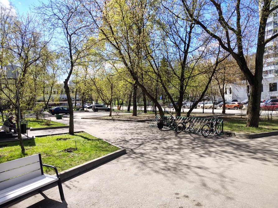 Cycle parking and benches along a paved street