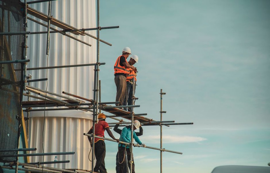 Workers assessing a construction site plan
