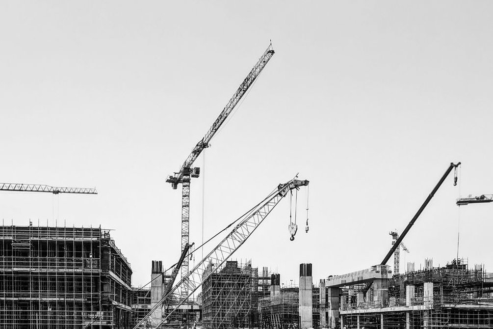Active construction site with cranes and workers
