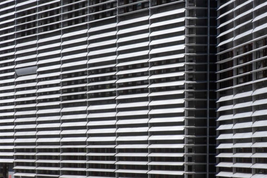 Deep exterior fins reduce direct sun at glazed offices