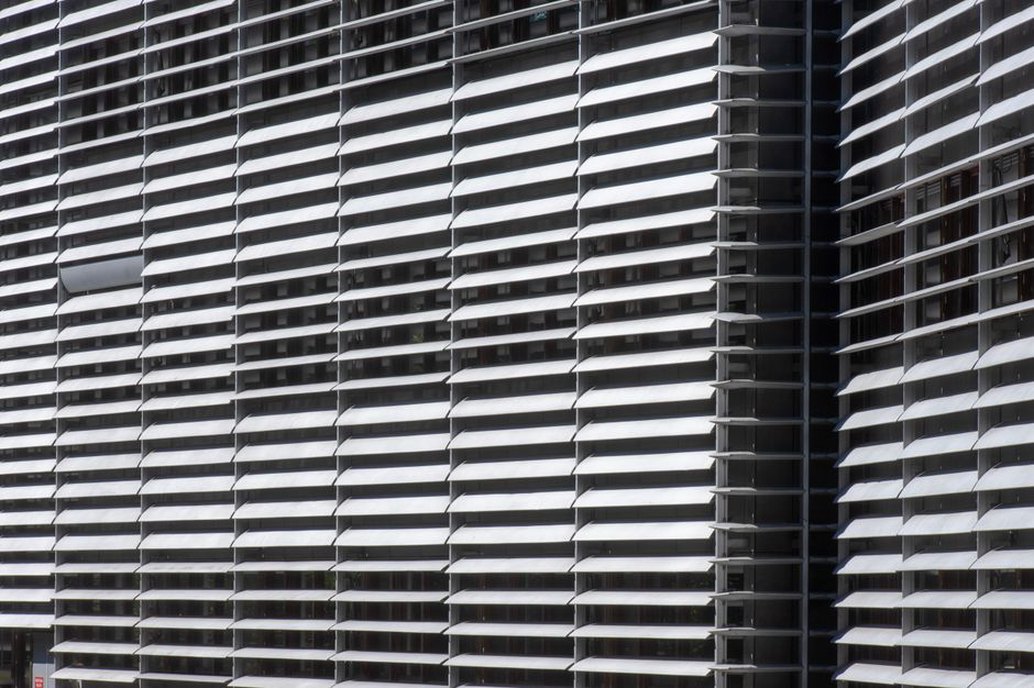 Deep exterior fins reduce direct sun at glazed offices