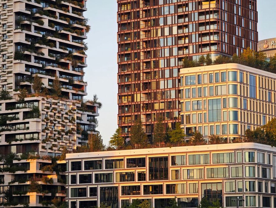 A modern high-rise building with solar panels and green terraces, illustrating eco-friendly architecture