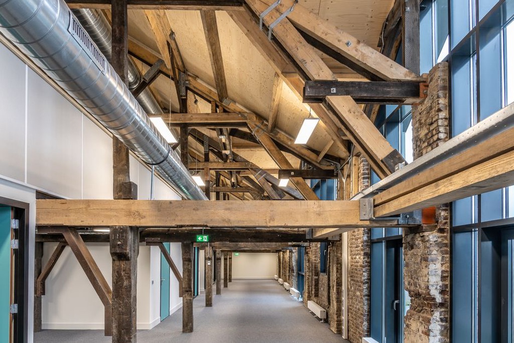 Restored industrial interior with new services integrated discreetly