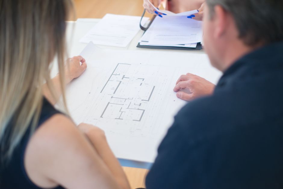 Designers reviewing circulation routes on a hospital plan