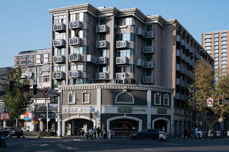 Separate entrances serve shops and apartments along one frontage