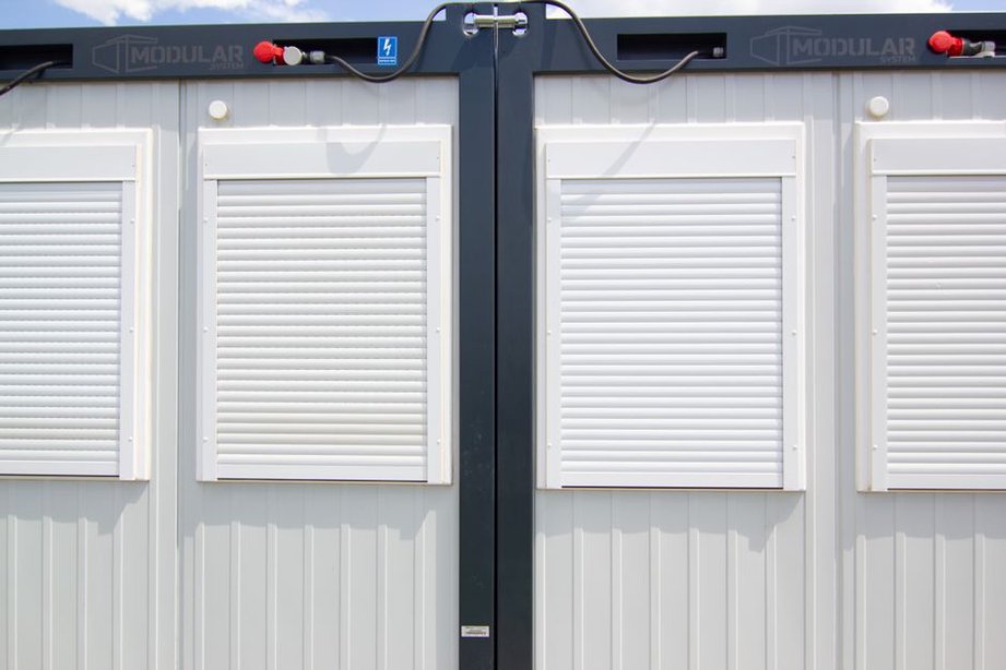 Technicians fitting building services inside factory-built units