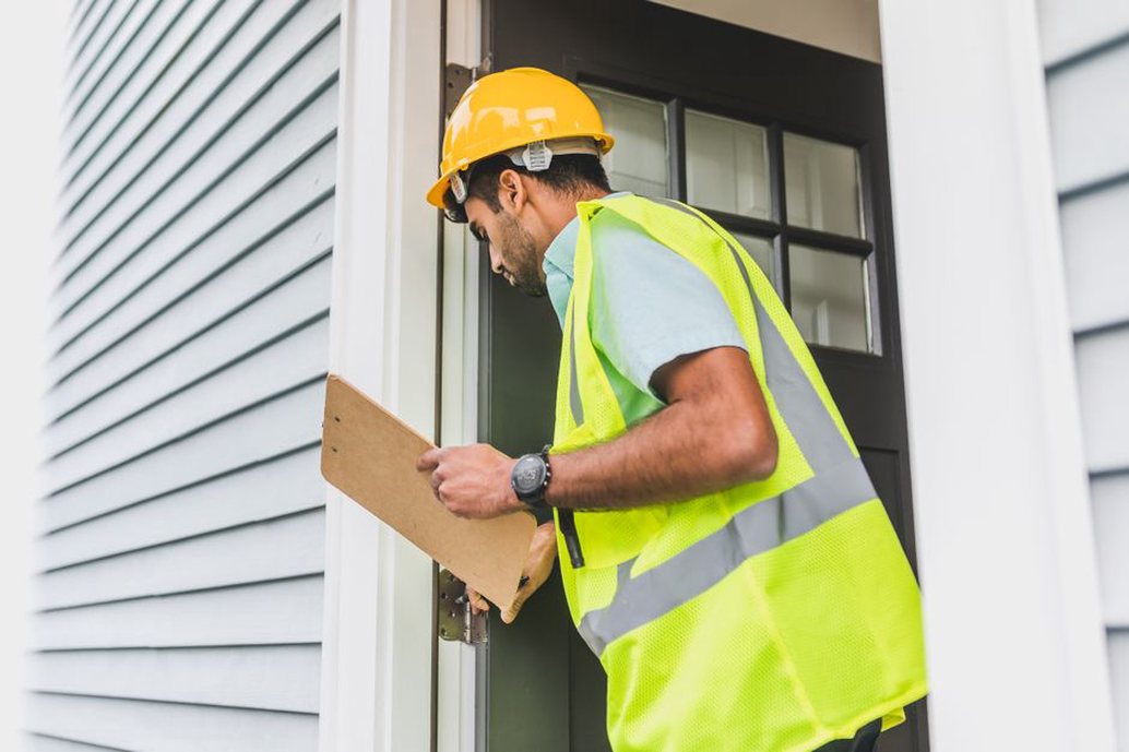 Inspector checking structural framing in a new home