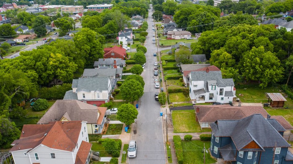Low-density development separated by wide roads and parking areas