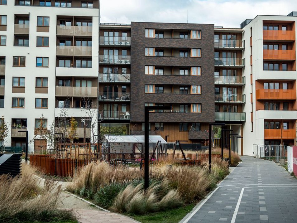 A planted drainage corridor beside a walkable development