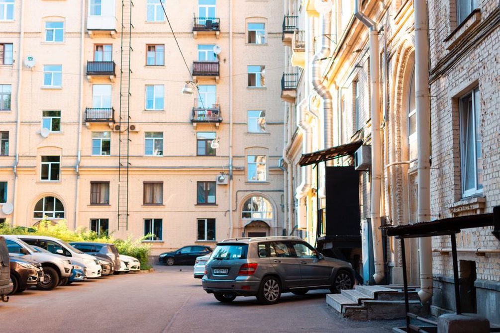 Residential blocks shield a courtyard from street traffic