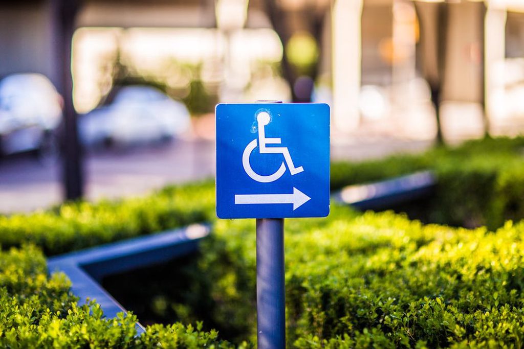 Clear signs beside a step-free public entrance