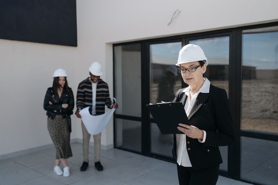 Facilities staff and designer review an occupied building plan