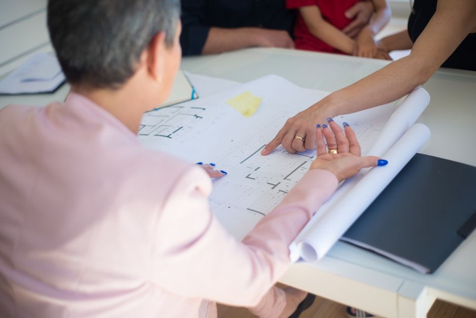 Architect and client examine plans together