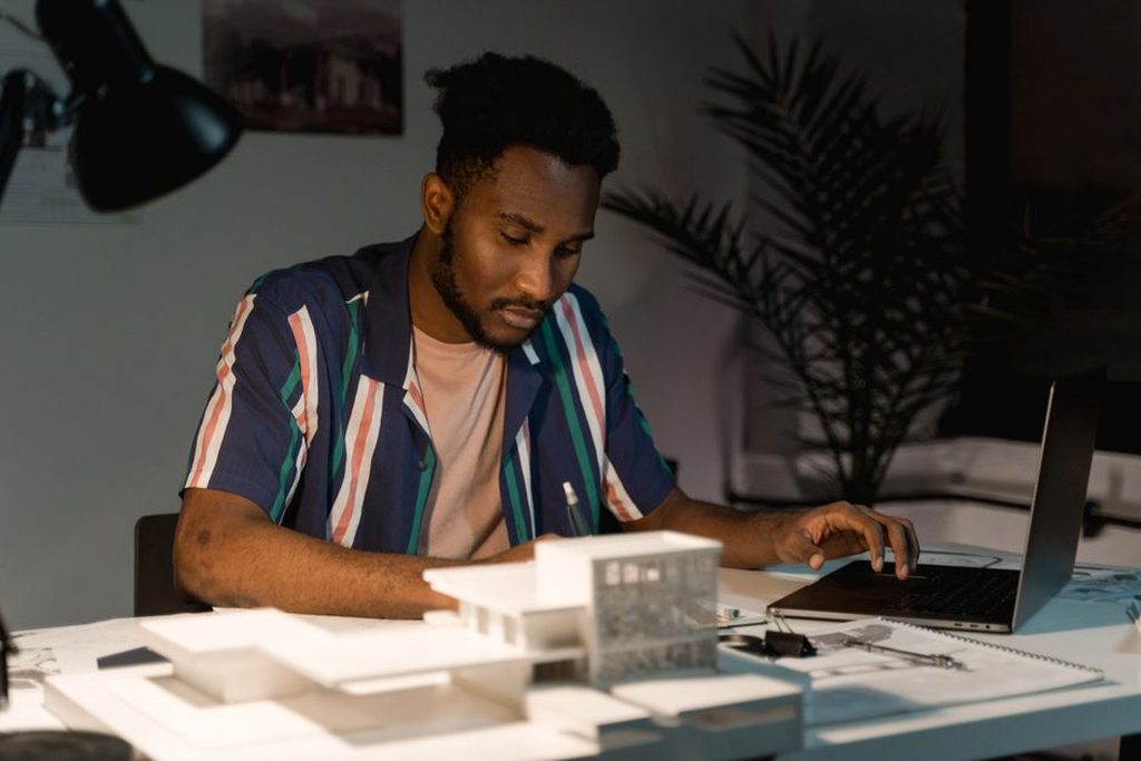 Architect checks a project page on a laptop