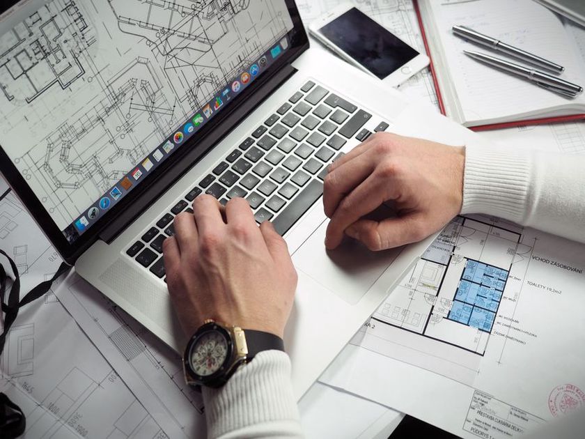 Revised building plans open beside the permit register