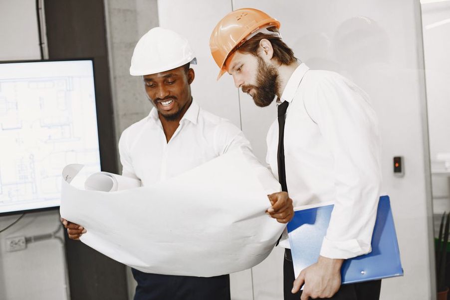 Colleagues compare drawings with completed building photographs