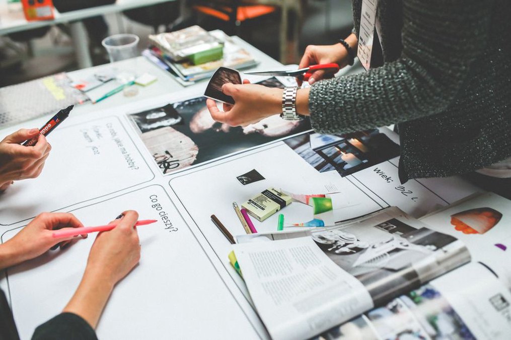 Designers selecting approved material for a project update