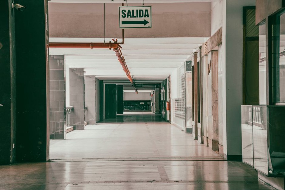 Visitors follow temporary signs through a corridor