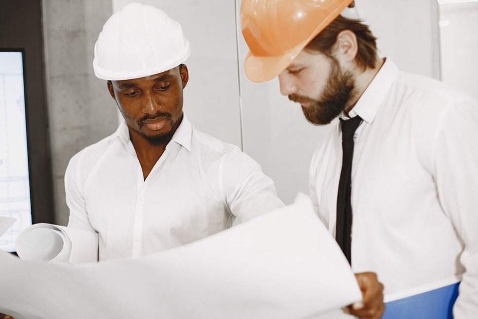 Architect and engineers compare plans during a compliance review