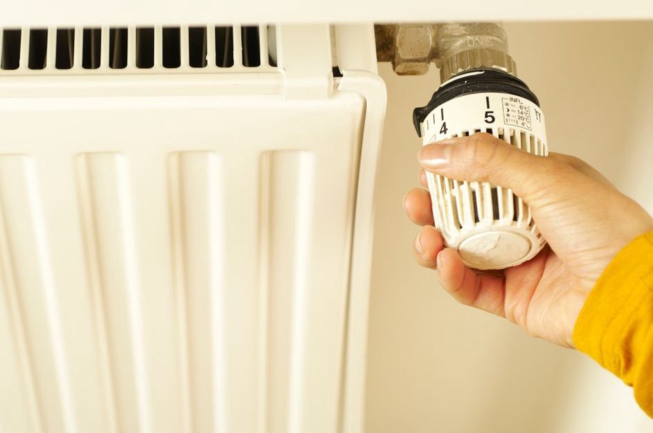 Thermostat beside a window in a lived-in room