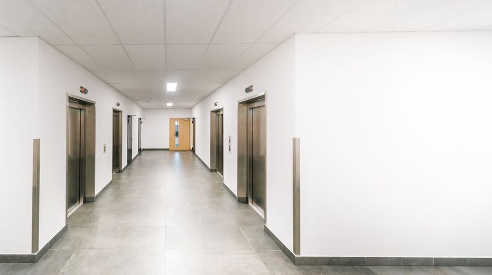 Clear directions beside a hospital lift lobby