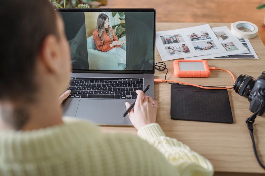 Photos being sorted beside an external drive