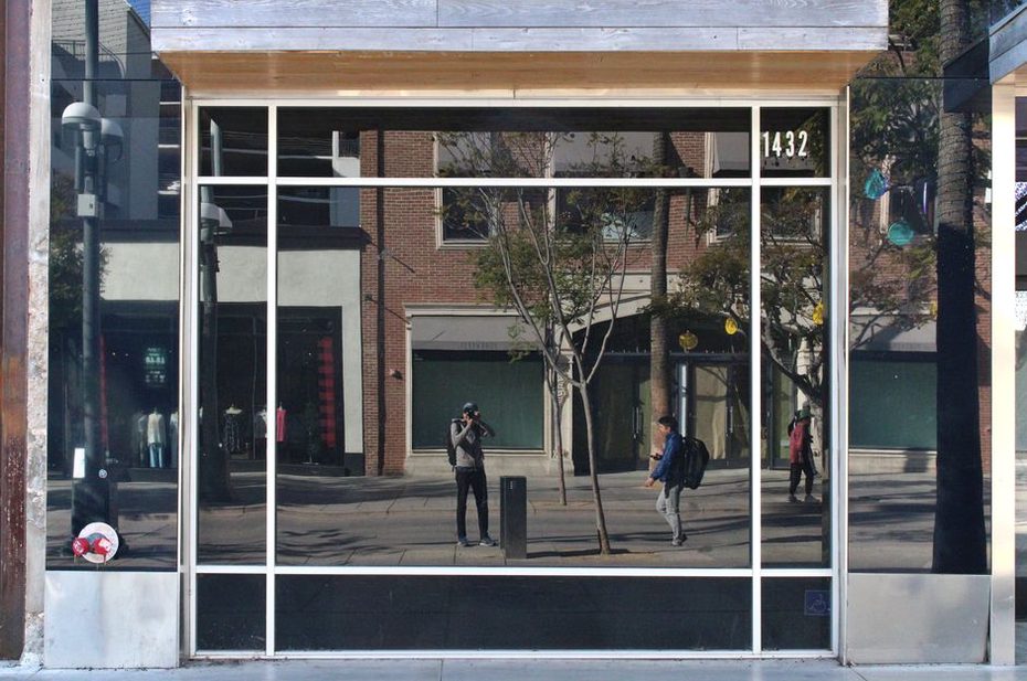 Shop entrances facing a broad pedestrian sidewalk