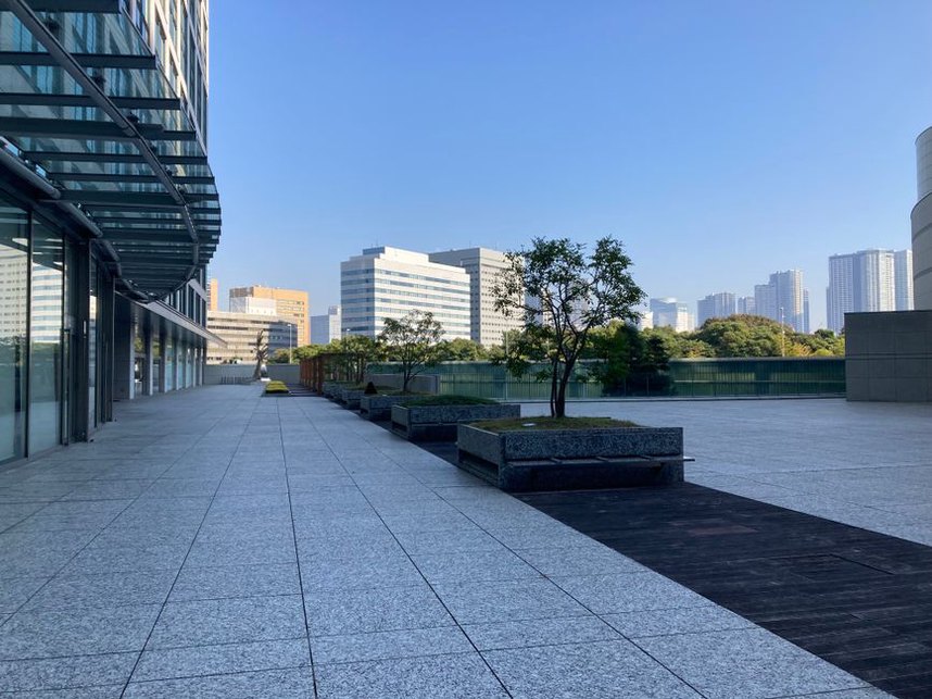 Planters define an outdoor break area above the street