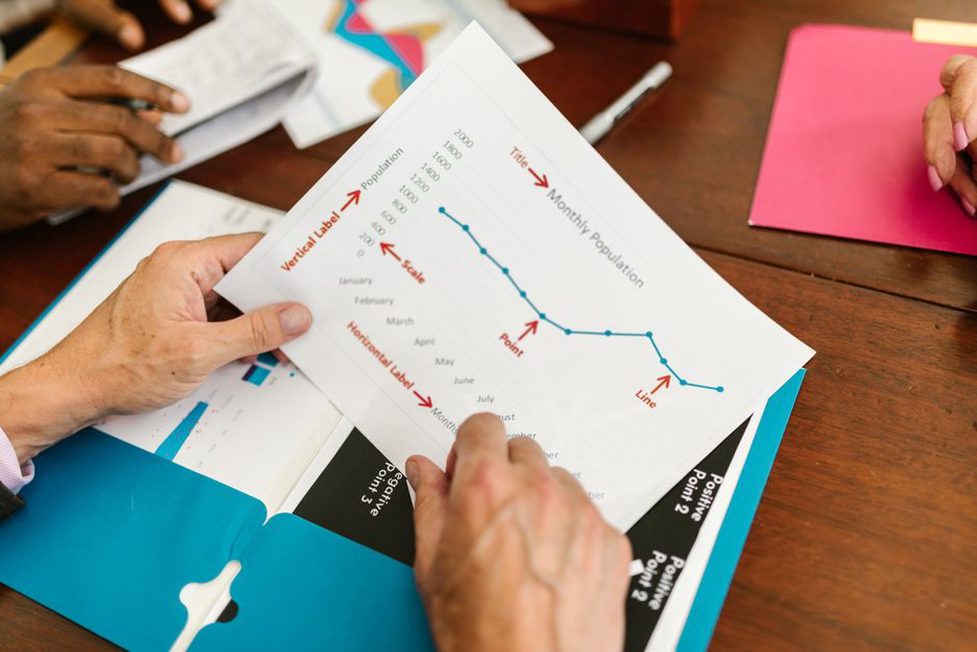 Colleagues check dates against a project schedule