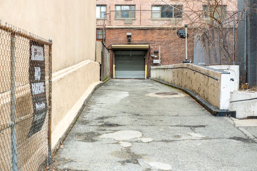 A service entrance meets a pedestrian route at the curb